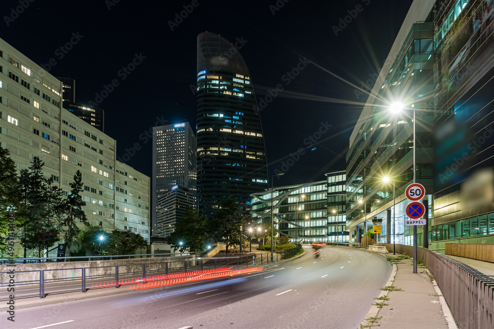 Traffic at Main Avenue in La Defense Business District at Night Buildings