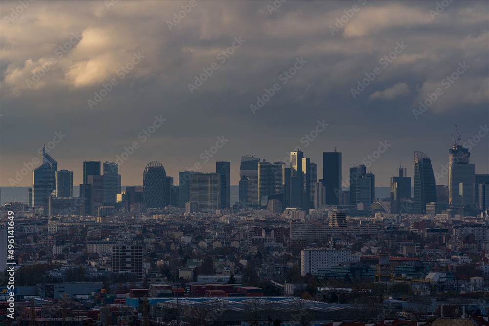 Fototapeta premium La Defense Business District Under Stormy Clouds With Sunlight on Towers Paris