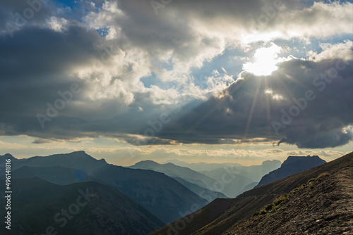 Cloudy Sky Over French Alps Mountains With Sun and Peaks