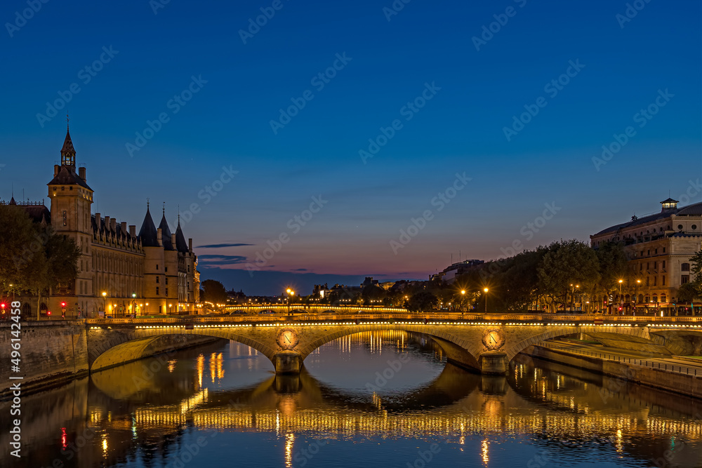 Enlightened Bridge Over Seine River at Blue Hour in Paris Center With Reflections