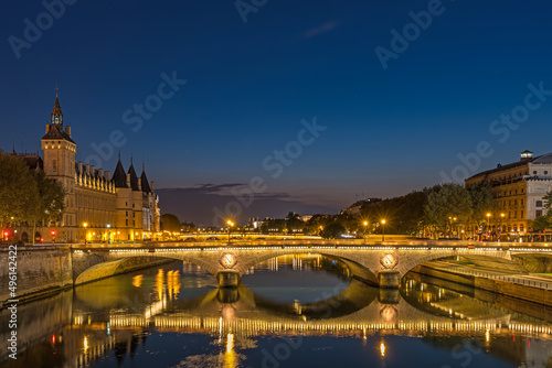 Dusk in Paris With Blue Sky and Enlighened Bridges and Buildings With Reflections On Seine River