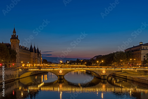 Enlightened Bridge Over Seine River at Blue Hour in Paris Center With Reflections