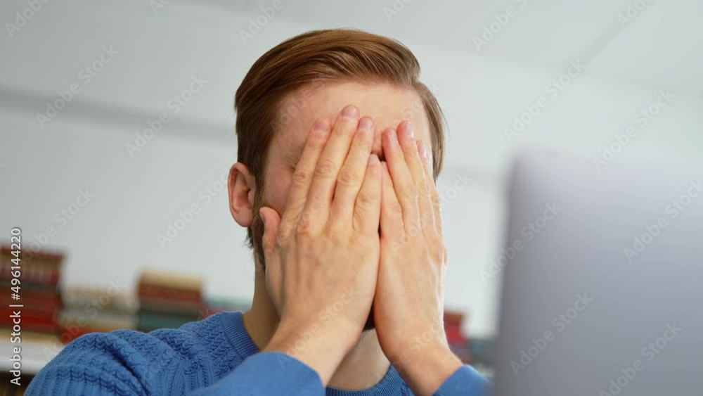 Upset male receiving bad news using computer Upset male receiving bad news using computer
