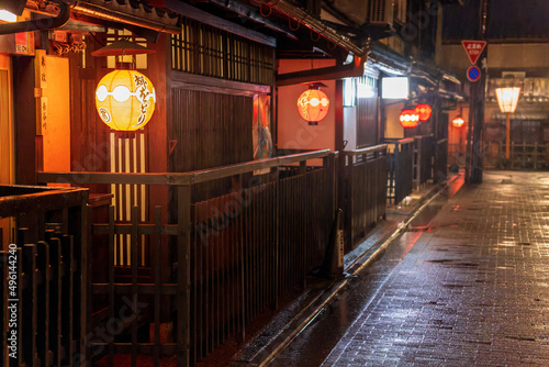 Glowing lanterns in front of small shops at night