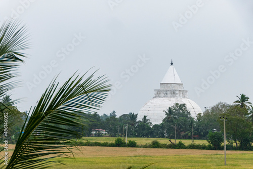 Tissa, Sri Lanka The Tissamaharama Stupa Buddhist temple looming over fields. photo