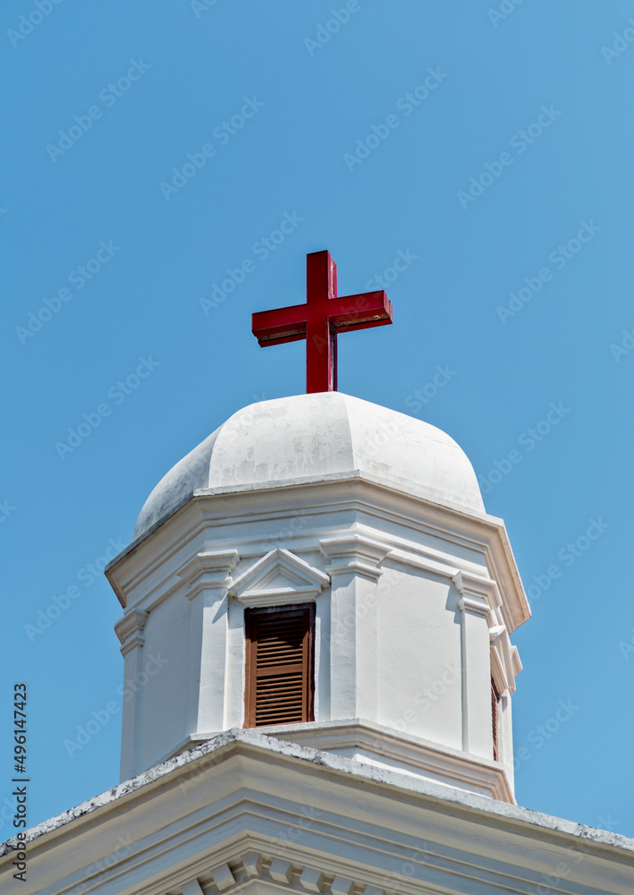 A red cross on the roof of church A red cross on the roof of church