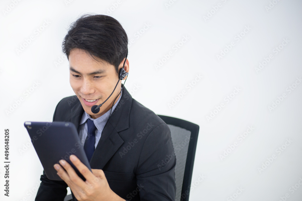 Asian business man staff working at service desk talking on phone in a call center, portrait of men operator agent with headset, customer service or technical support concept, copy space Asian business man staff working at service desk talking on phone in a call center, portrait of men operator agent with headset, customer service or technical support concept, copy space