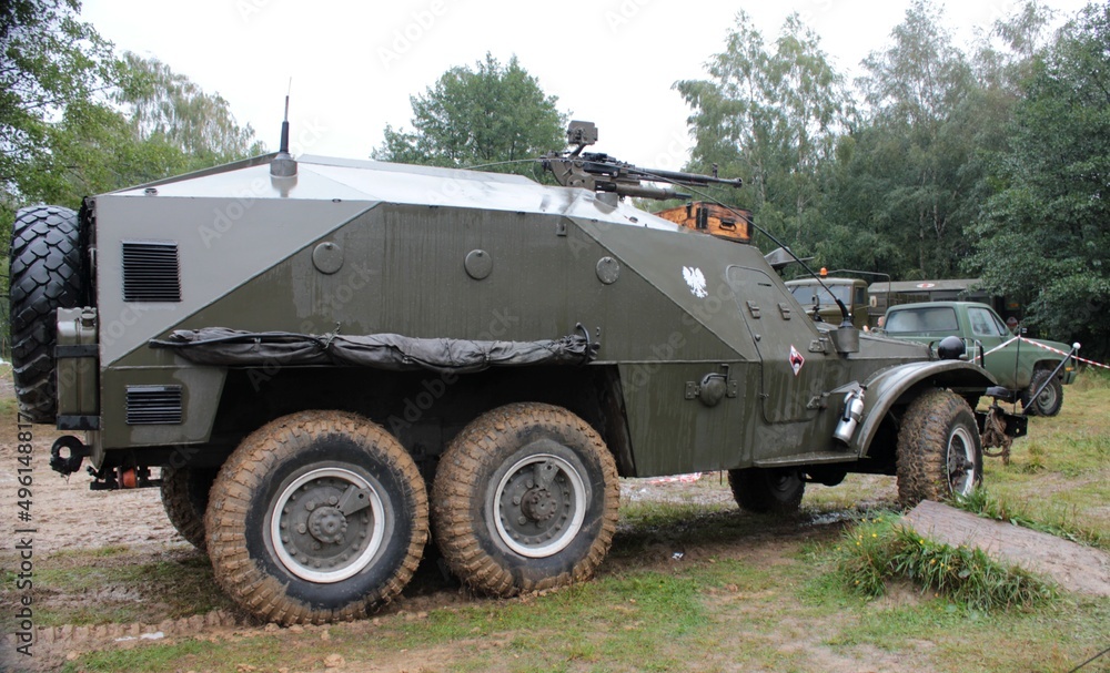 An historic military transport vehicle standing in the forest An historic military transport vehicle standing in the forest