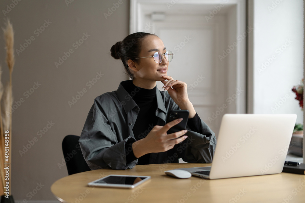 The manager is a woman with glasses working in the office using a laptop computer online project report The manager is a woman with glasses working in the office using a laptop computer online project report