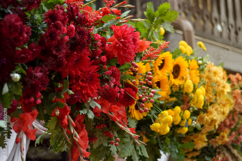 Colourful wedding decorations. Wedding arch with fresh flowers. Sunflower wedding decor. Wedding day.