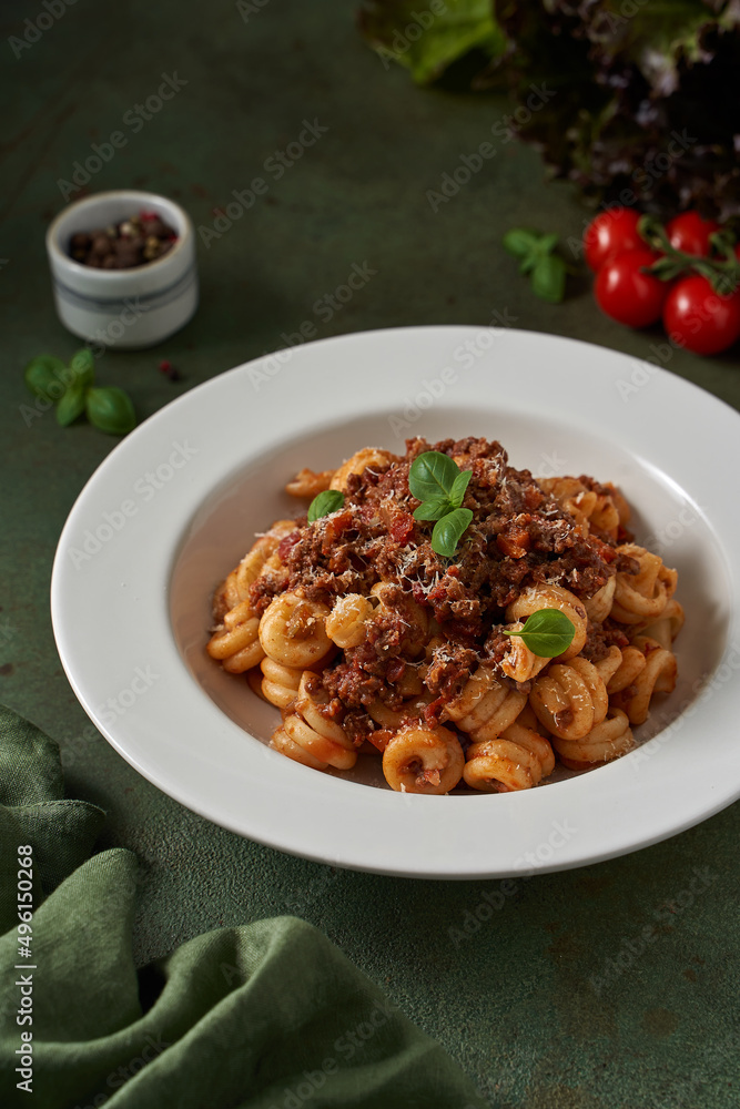 Fototapeta premium pasta bolognese on a dark green background