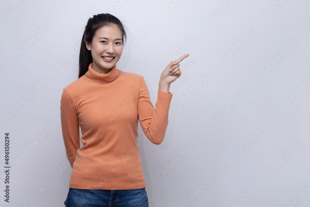 Happy Asian Woman Pointing Her Finger to Blank Copy Space Happy Asian Woman Pointing Her Finger to Blank Copy Space