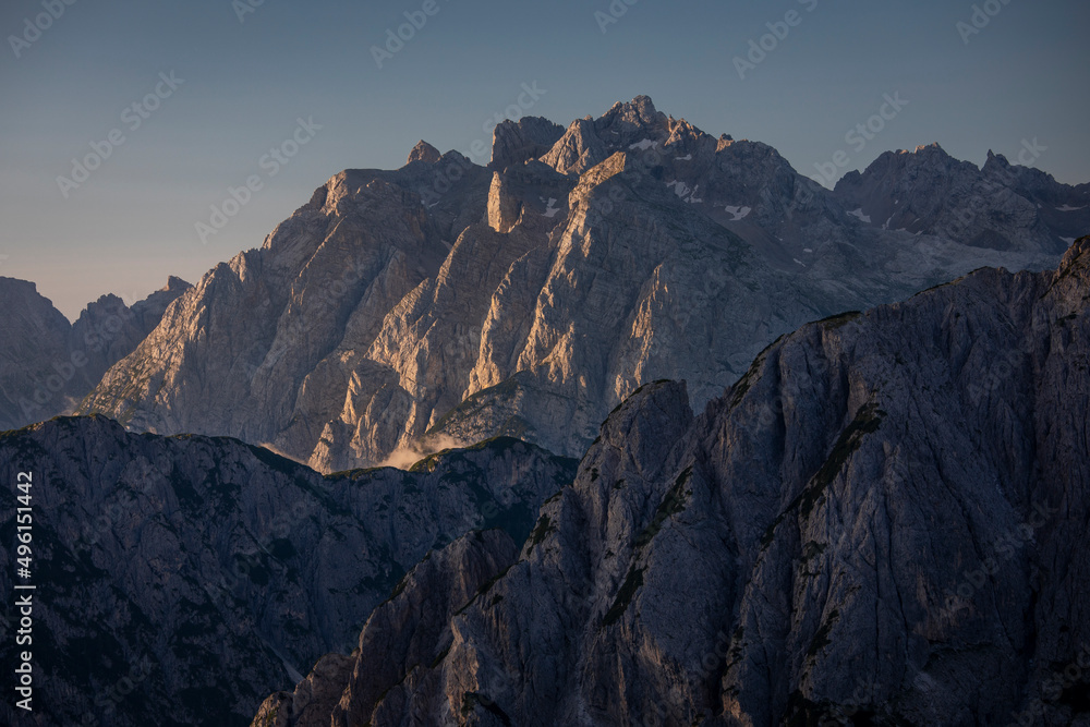 Mountain layers during sunrise with clear blue sky in the Dolomite Alps in South Tyrol, Italy.