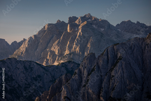 Mountain layers during sunrise with clear blue sky in the Dolomite Alps in South Tyrol, Italy.