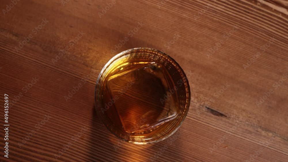 ice cube in a glass of whiskey alcohol bar bourbon scotch ice cube in a glass of whiskey alcohol bar bourbon scotch