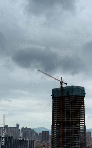 Unfinished building under dark clouds