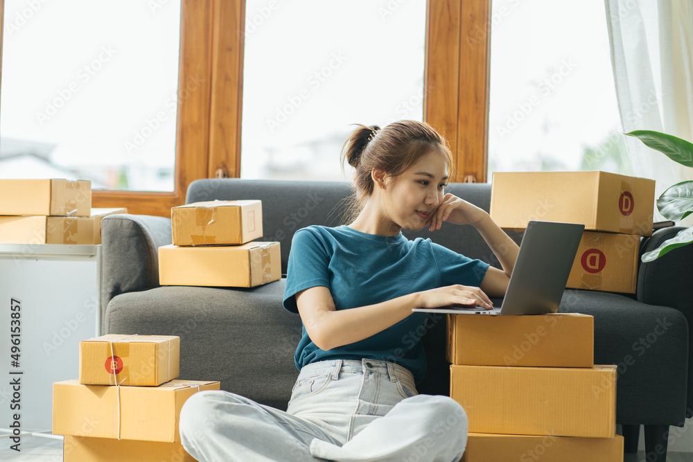 Starting Small business entrepreneur SME freelance,Portrait young woman working at home office, BOX,smartphone,laptop, online, marketing, packaging, delivery, SME, e-commerce concept Starting Small business entrepreneur SME freelance,Portrait young woman working at home office, BOX,smartphone,laptop, online, marketing, packaging, delivery, SME, e-commerce concept