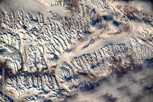 Fototapeta Naklejka Na Ścianę i Meble -  Beauty of snow capped mountain range. digital enhancement. elements by nasa