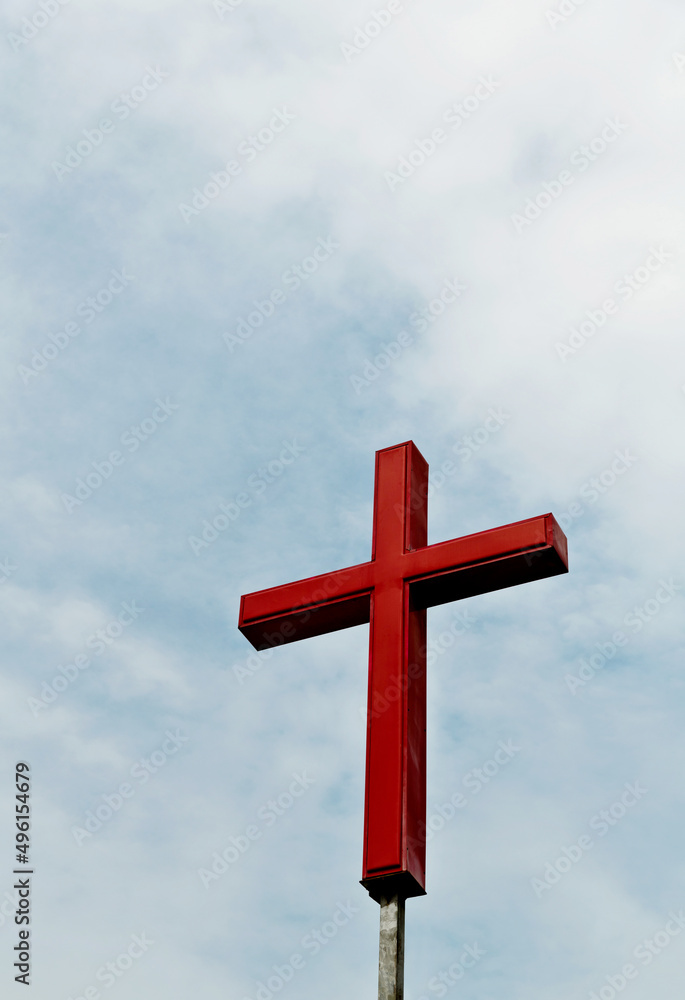 A cross under the cloudy sky
