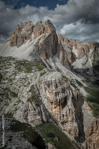 Mountain Paternkofel in Three Peaks Nature Reserve in the Dolomite Alps in South Tyrol with clouds in blue sky.