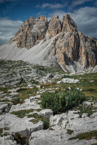 Mountain Paternkofel in Three Peaks Nature Reserve in the Dolomite Alps in South Tyrol with clouds in blue sky.