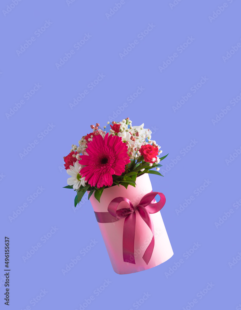 Pink gift box with various spring flowers on purple background. Mother's Day idea. Copy space. Pink gift box with various spring flowers on purple background. Mother's Day idea. Copy space.