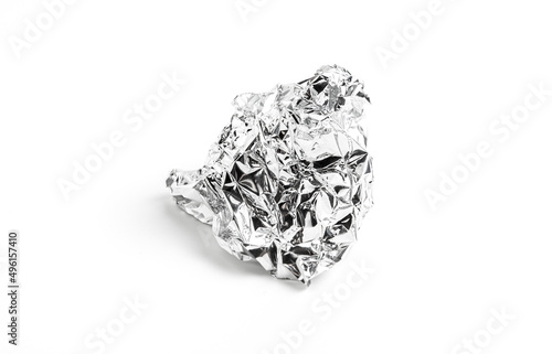 Food grade aluminum foil paper for chocolate packaging. Shiny aluminum wrap without chocolate candy on a white background. Texture of used crumpled aluminium food foil.
