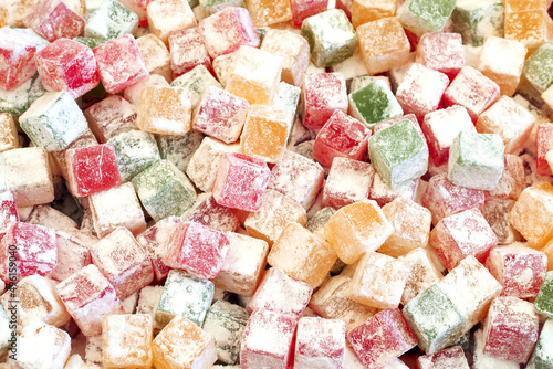 Fruit paste sugar covered candy background, different colors