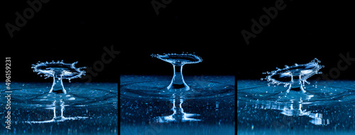 Splash and umbrella on black background. Reflection on the surface of the water.