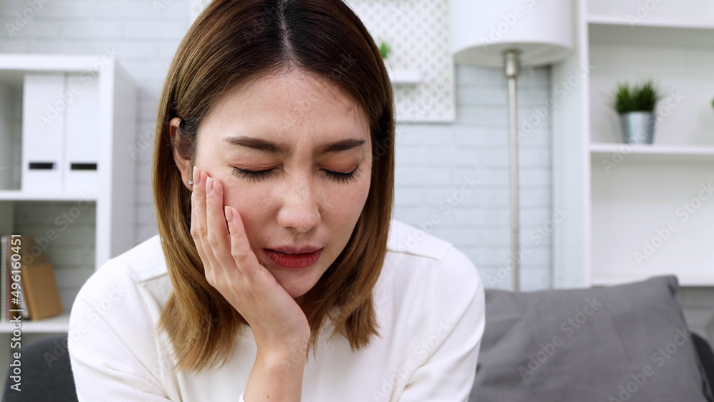 Asian woman suffering from toothache, Cavities or tooth decay concept Asian woman suffering from toothache, Cavities or tooth decay concept