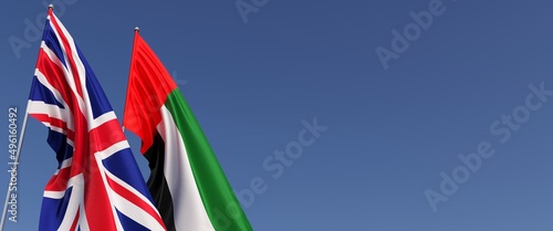 Flags of the United Kingdom and the UAE on flagpoles on side. Flags on a blue background. Great Britain, England. United Arab Emirates. Abu Dhabi. 3D illustration.