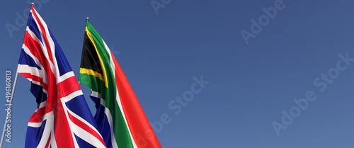 Flags of the United Kingdom and South Africa flagpoles on side. Flags on a blue background. Great Britain, England. Cape Town. 3D illustration.