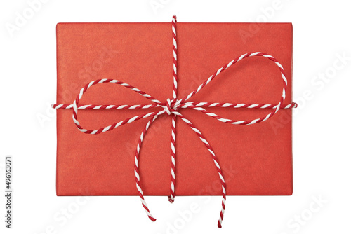 Christmas gift box wrapped in red paper with striped rope bow isolated on white background