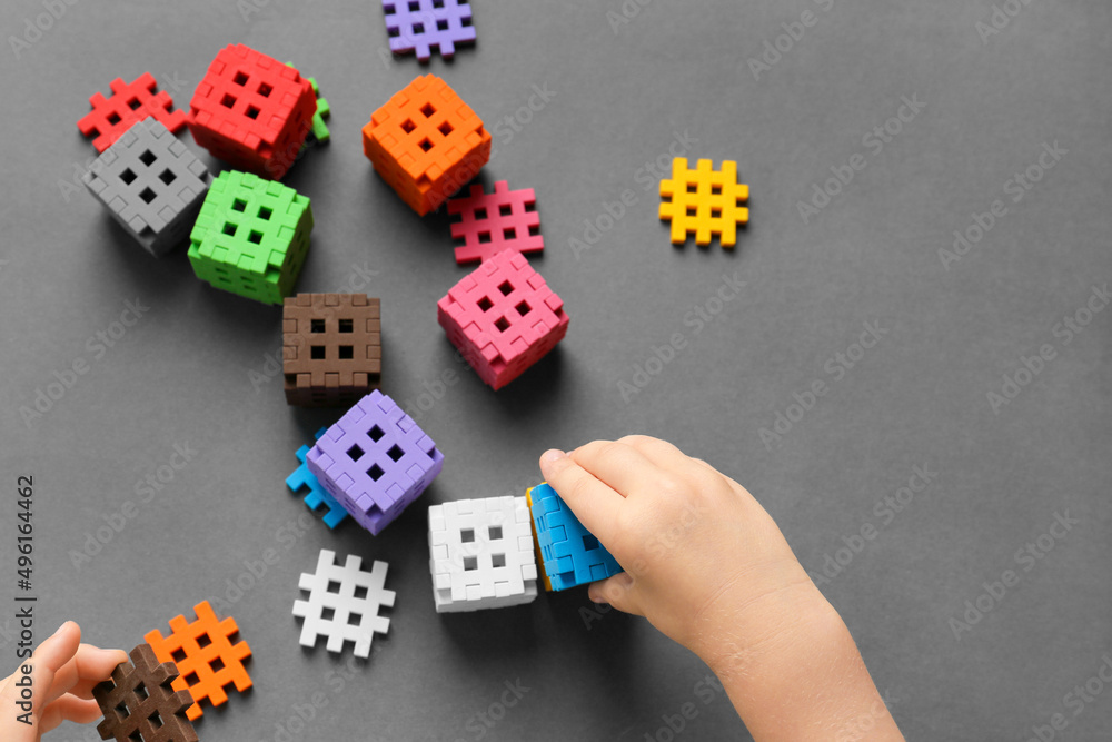 Child is playing with multi-colored blocks Child is playing with multi-colored blocks