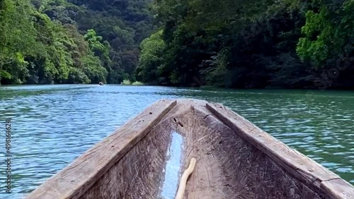 Dugout canoe on Chagres River in Panama. Motorized piragua or hampá (dugout canoe) travels up Chagres River to a Emberá indigenous village. Embera are indigenous people of Panama and Columbia. photo