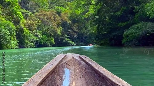 Dugout canoe on Chagres River in Panama. Motorized piragua or hampá (dugout canoe) travels up Chagres River to a Emberá indigenous village. Embera are indigenous people of Panama and Columbia. photo
