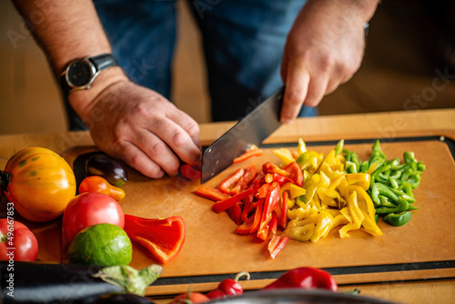 Chef cutting fresh and delicious vegetables for cooking