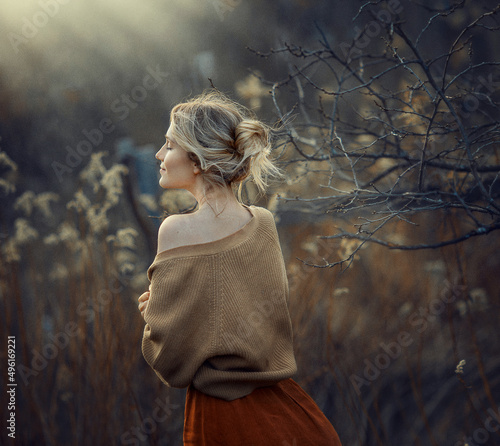 a girl in early spring in a flowering willow, photos with noise effect and selective focus