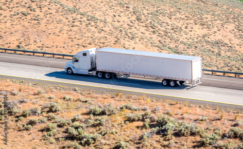 Long white semi-truck on the highway