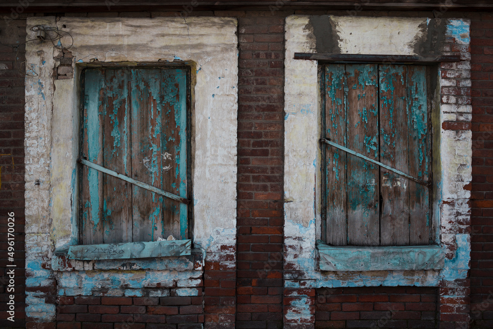 Two wooden windows in abandoned old countryside house.