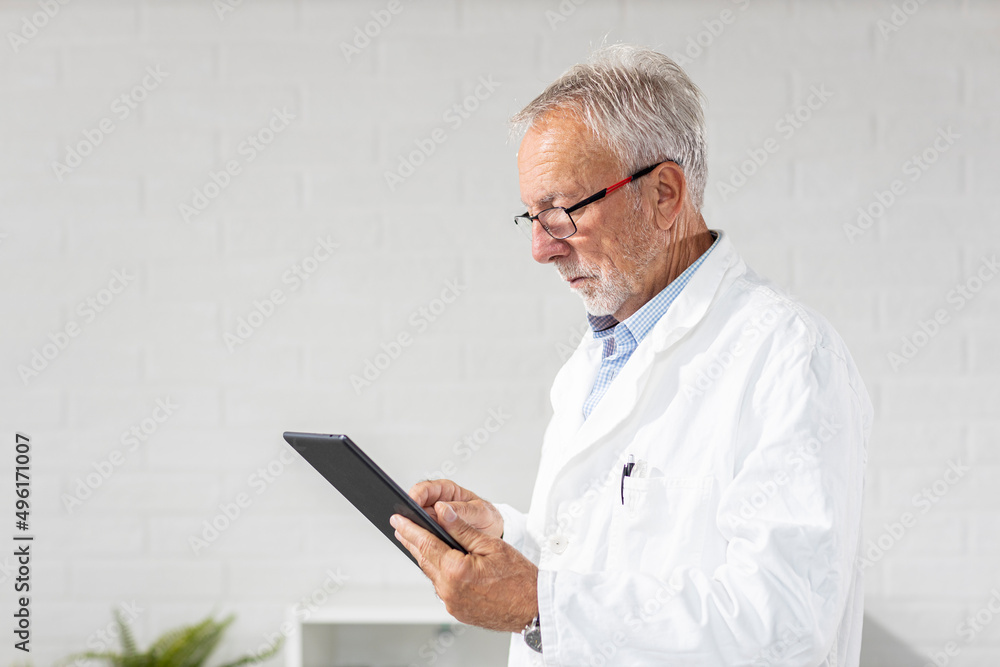 Portrait of doctor with tablet on hand and glasses on head at ambulance Portrait of doctor with tablet on hand and glasses on head at ambulance
