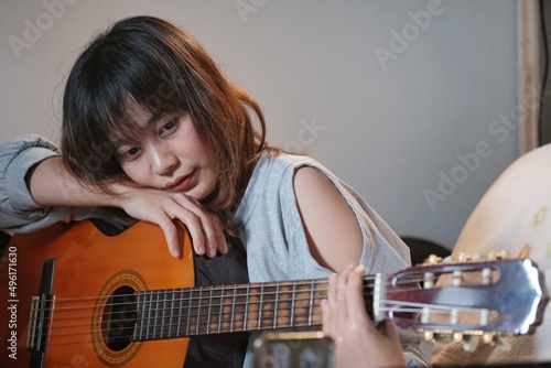 woman playing acoustic guitar. Musician woman in studio with classic guitar