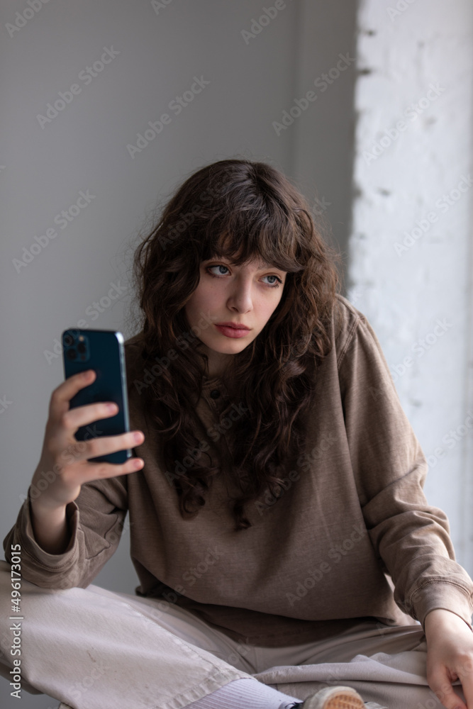 Attractive young woman with curly hair takes selfie. Attractive young woman with curly hair takes selfie.