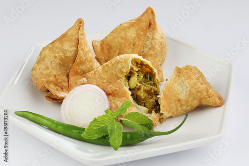 Veg Samosa - is a crispy and spicy Indian triangle shape snack which has crisp outer layer of maida filling of mashed potato, peas and spices