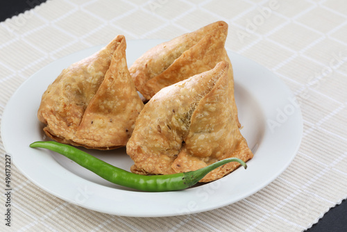 Veg Samosa - is a crispy and spicy Indian triangle shape snack which has crisp outer layer of maida filling of mashed potato, peas and spices
