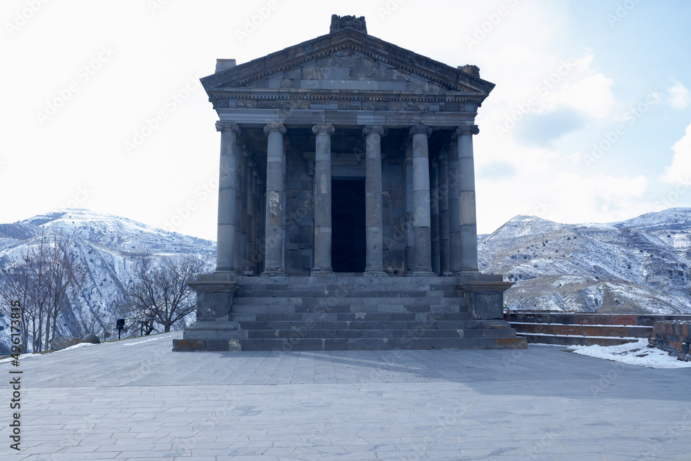an ancient temple stands among the winter mountain peaks
