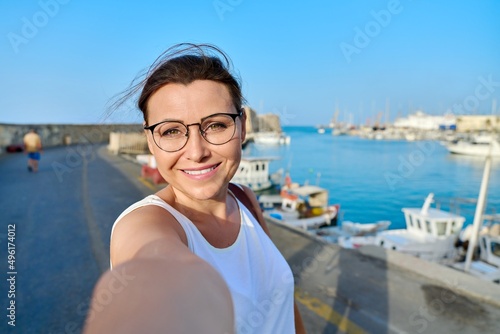 Fotografie Close up face of happy middle aged woman taking selfie portrait