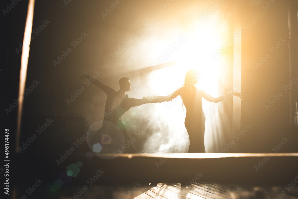 Naklejka premium Couple of two professional ballroom dancers is dancing on loft studio. Beautiful art performance with heavy smoke. Sport life concept. Passion and emotional dance.