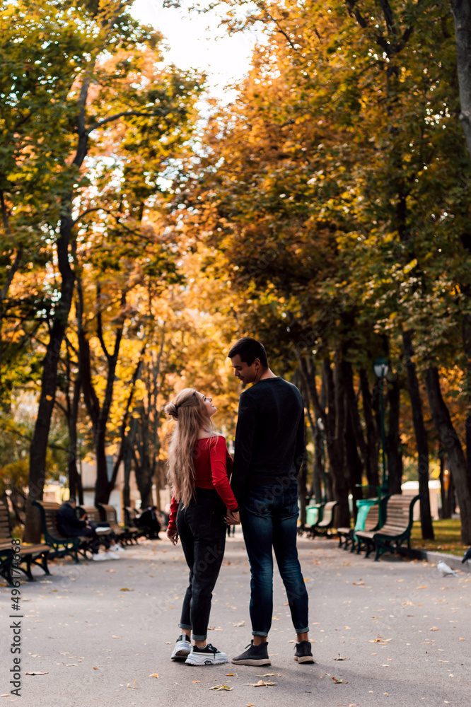 Couple in love walking in the park holding hands Couple in love walking in the park holding hands