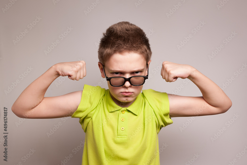 nerd boy shows his muscles with super hero power nerd boy shows his muscles with super hero power